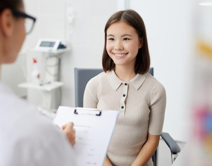 smiling-girl-in-doctors-office-QBNEG28.jpg